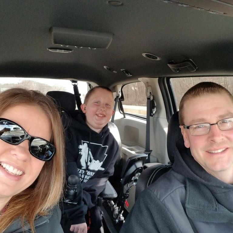 Josh Scoble & Family smiling together in a car. 2019